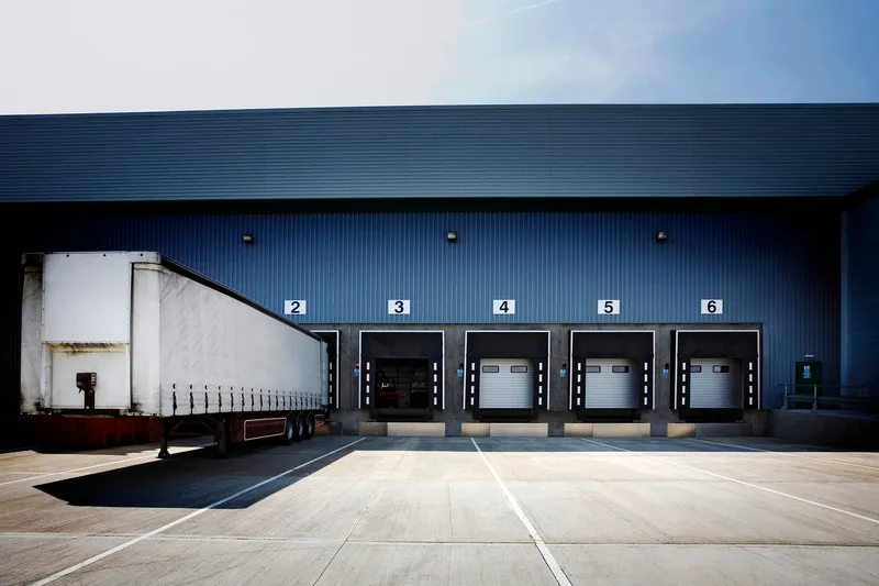 Image of a tractor trailer at the loading dock of an Amazon 3PL shipping company, highlighting efficient supply chain operations