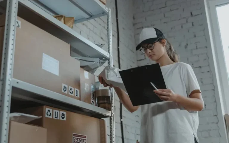 Warehouse worker organizing shelves and preparing for peak 2024 holiday season, confirming inventory quantity on hand