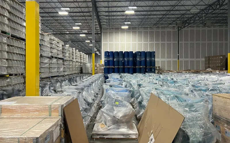 Warehouse preparing for peak 2024 holiday season with pallets stacked for storage and organized pallets ready for outbound shipment