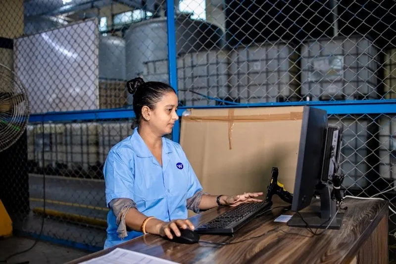Warehouse worker at a packing station using WMS software for streamlined fulfillment operations